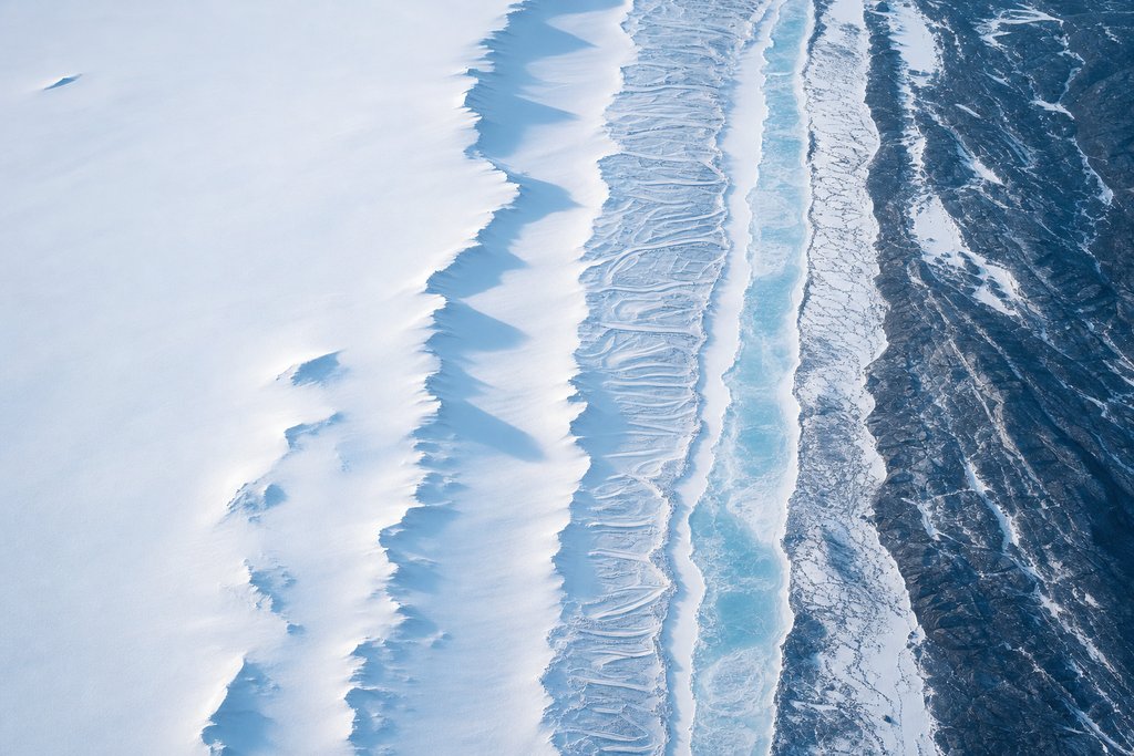 Aerial view of a snowfield divided into six adjacent parallel bands of clearly different width running edge to edge — the plate for how we score page
