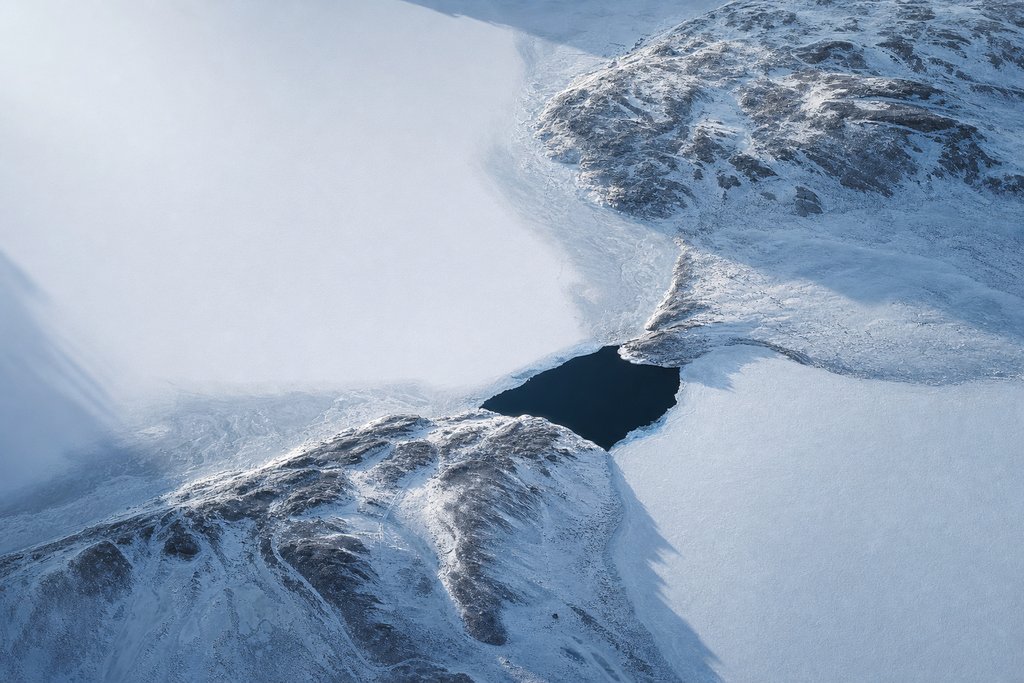 Aerial view of two frozen lakes joined by one short, wide, completely clear dark channel — the plate for interac casinos in the payouts section