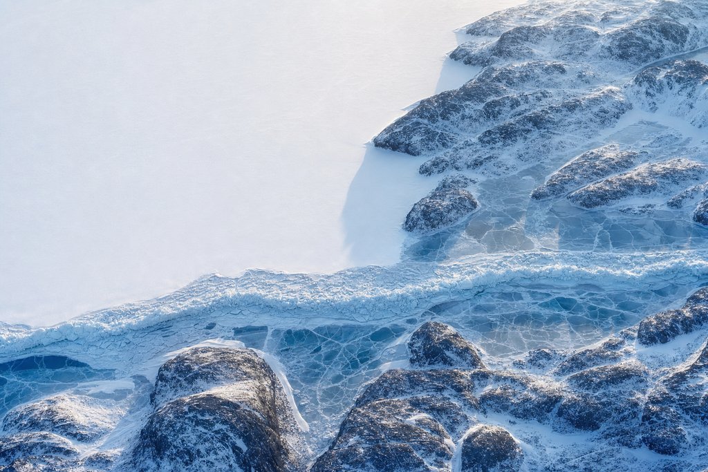 Aerial view of a wide frozen channel sealed completely across its full width by one unbroken ridge of pressure ice — the plate for self exclusion canada in the safer gambling section